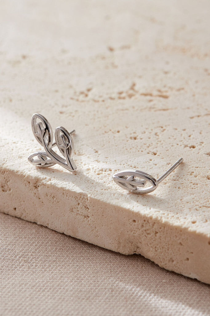 close up of the sterling silver asymmetrical olive leaf earrings