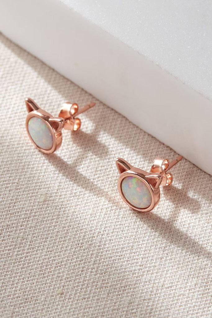 rose gold plated sterling silver earrings with round moonstone gems surrounded by rose gold silver, the studs are round with pointy cat ears