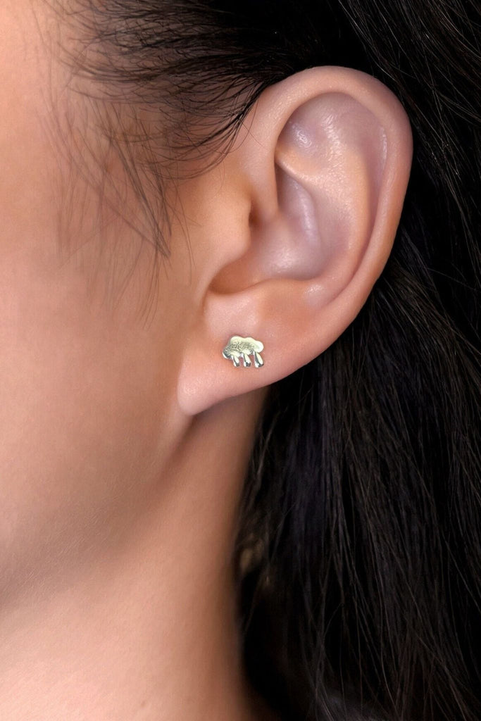 model wearing the silver rain cloud stud earring on the earlobe showing the dainty size of the earrings