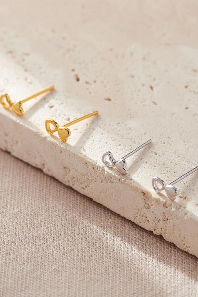 silver and gold dual love heart stud earrings, each earring features one solid love heart adjoined to an outline love heart