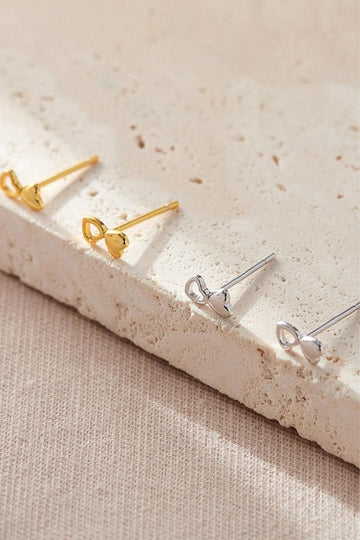 silver and gold dual love heart stud earrings, each earring features one solid love heart adjoined to an outline love heart