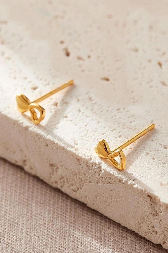 close up of the gold dual heart stud earrings