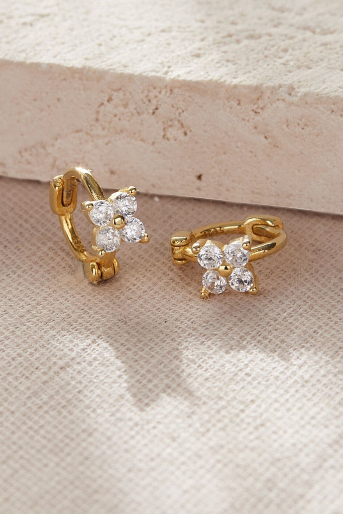 close up of the gold cz floral cartilage hoops