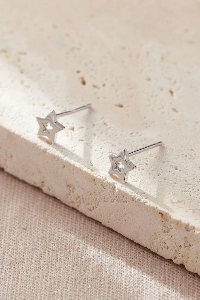 close up of the silver openwork star studs