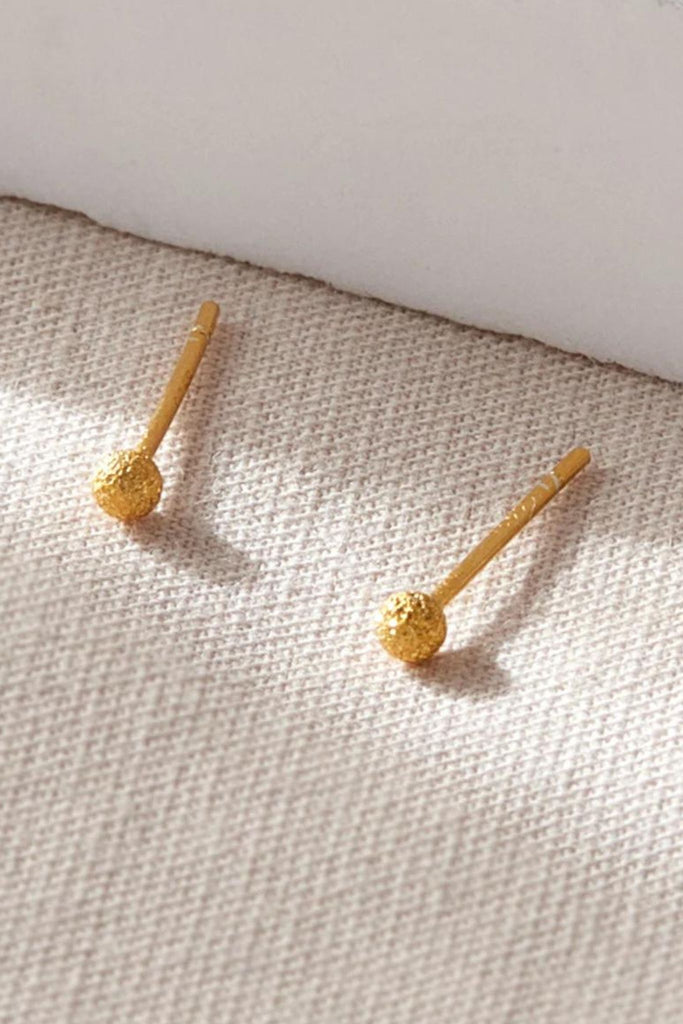 close up of the gold frosted ball stud earrings