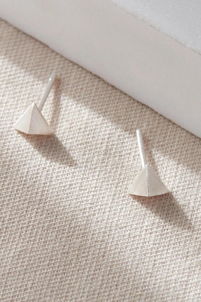 close up of the silver pyramid geometric studs