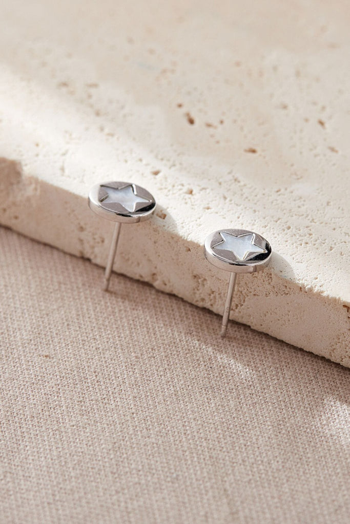 close up of the silver and mother of pearl star stud earrings