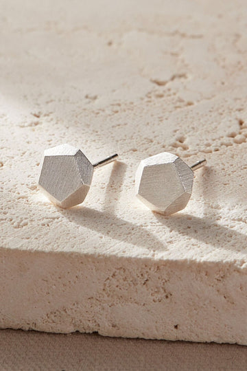 three dimensional hammered stud earrings, each face of the studs is pentagon shaped