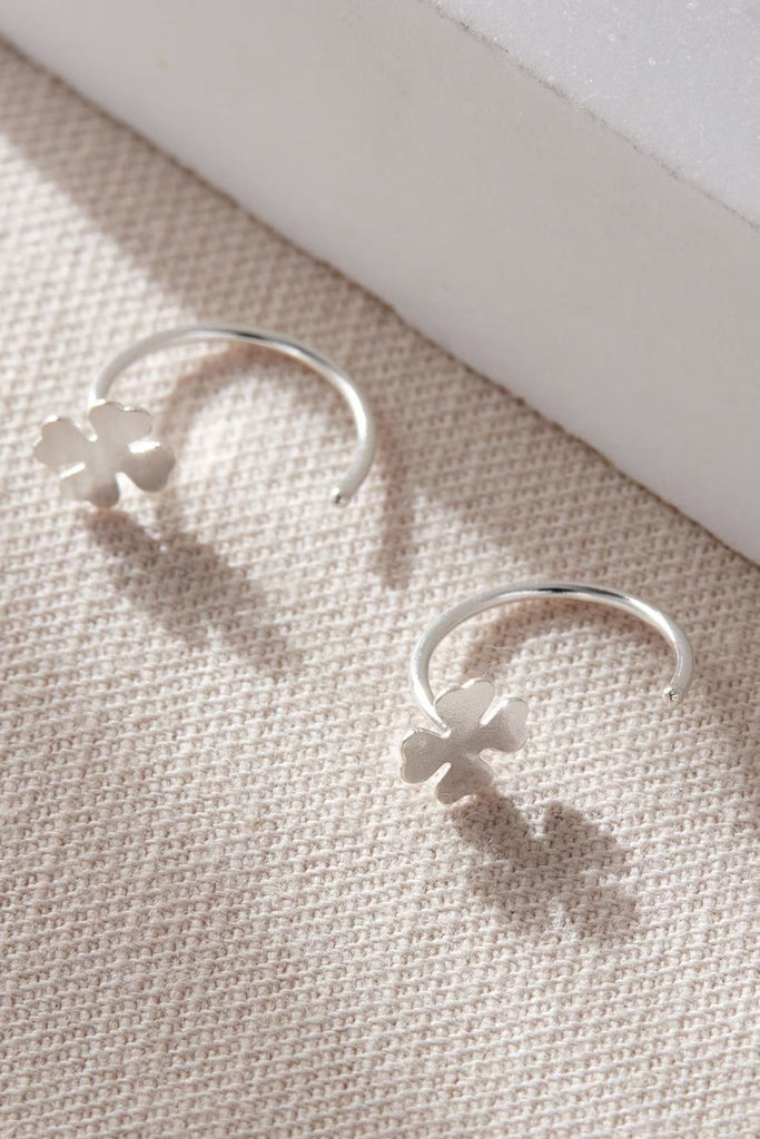 sterling silver four leaf clover hook earrings, the earrings hook through the earlobe and are held in place by the clover