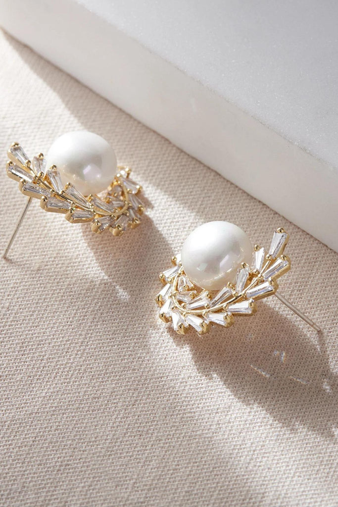 close up of the gold olive leaf pearl stud earrings