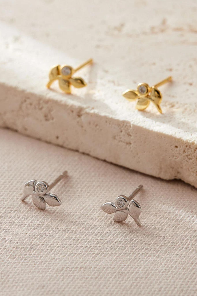 silver and gold coloured dainty olive leaf stud earrings. each earring had three leaves and one round cz crystal accent