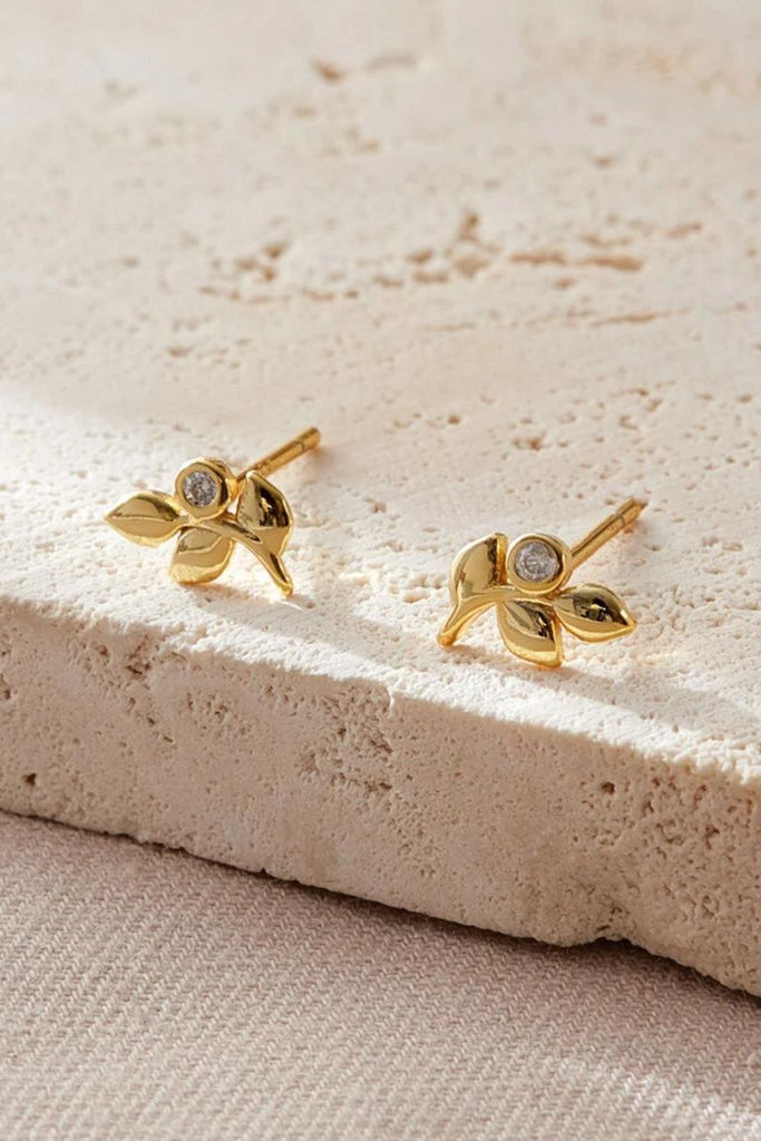 close up of the gold olive leaf stud earrings