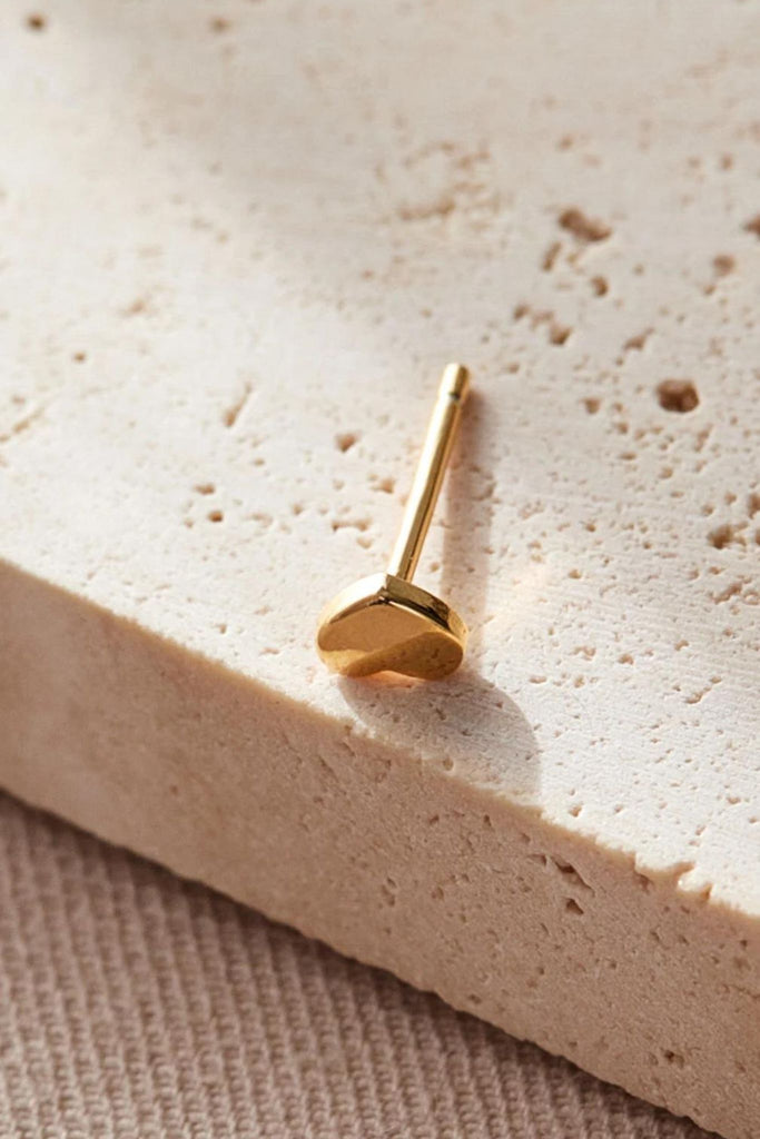 close up of the dainty gold star stud earrings