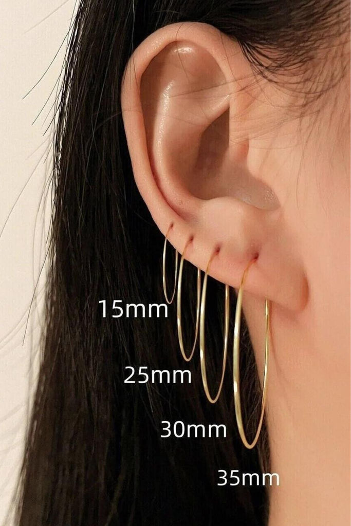 model wearing all four sizes of the oversized thin gold hoops, 15mm, 25mm, 30mm and 35mm hoops 