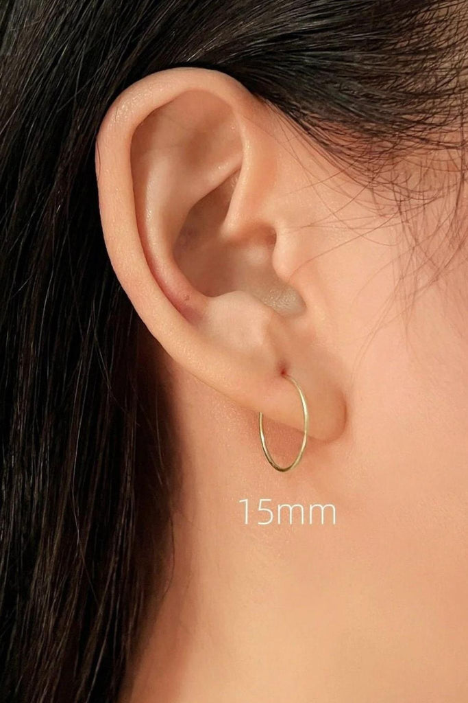 model wearing the 15mm gold hoop showing how it looks when worn