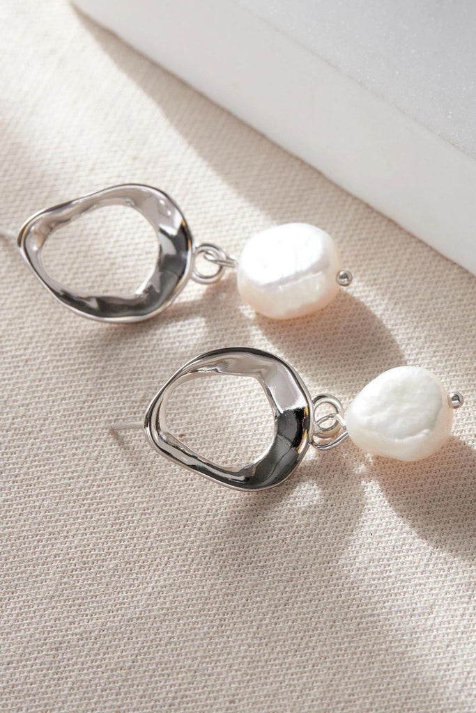 close up of the silver coloured pearl earrings