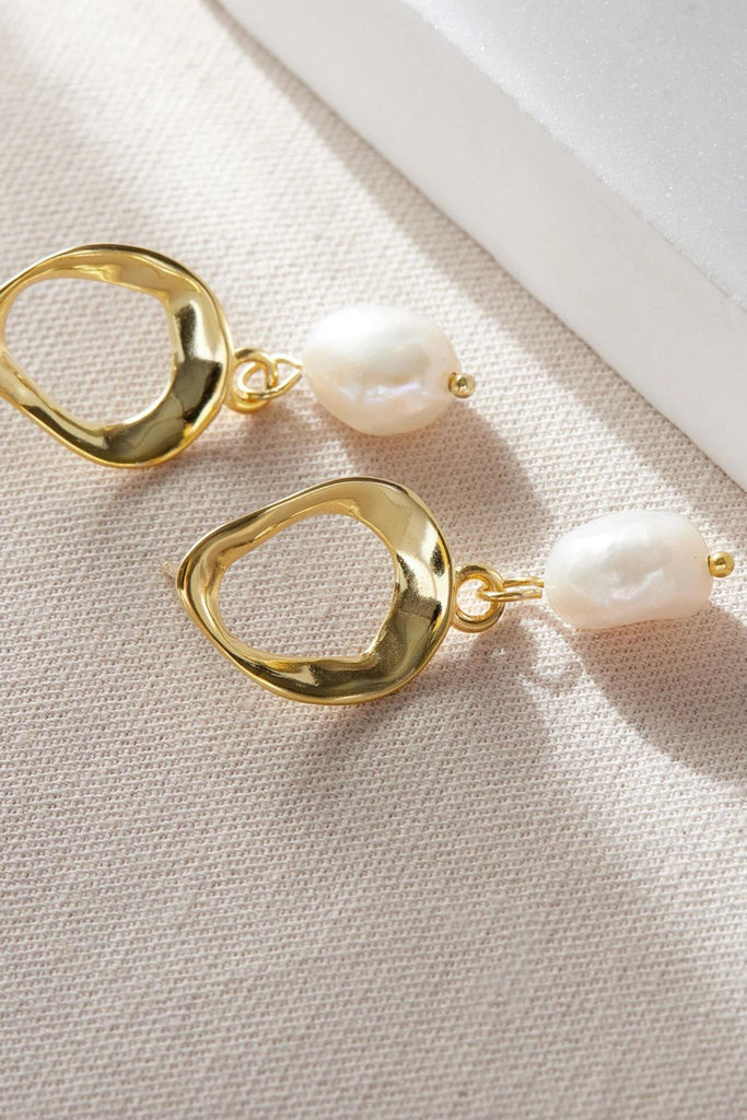 close up of the gold coloured pearl earrings