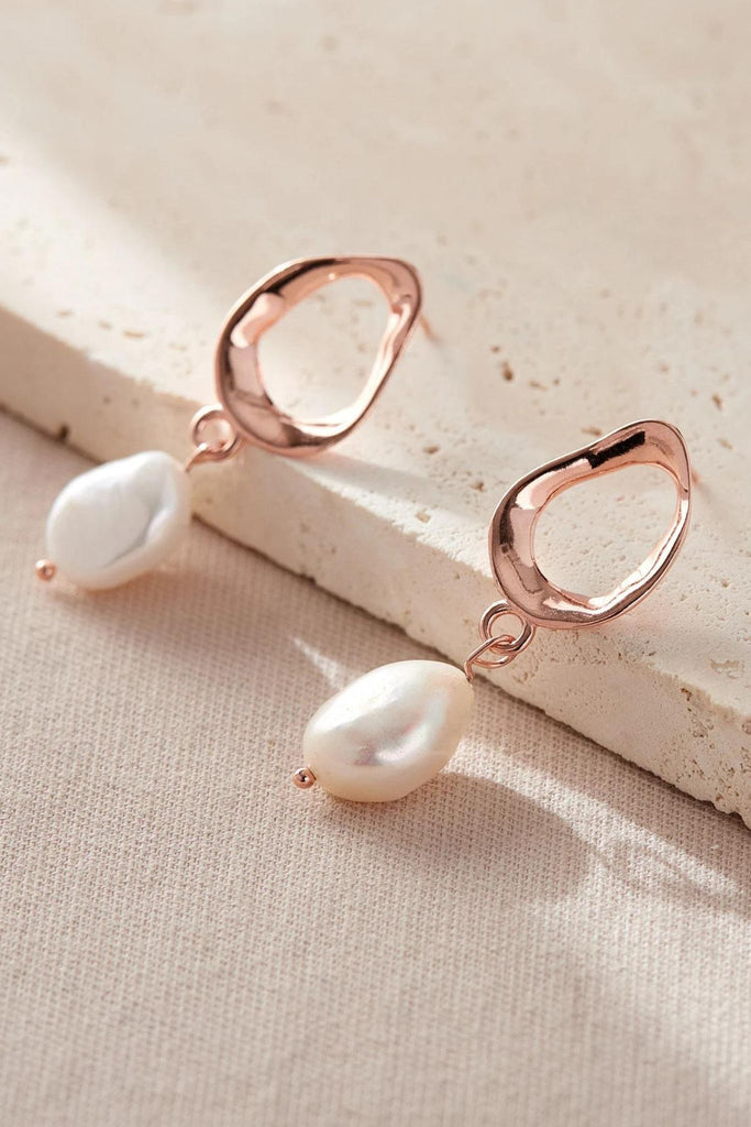 close up of the rose gold coloured pearl earrings