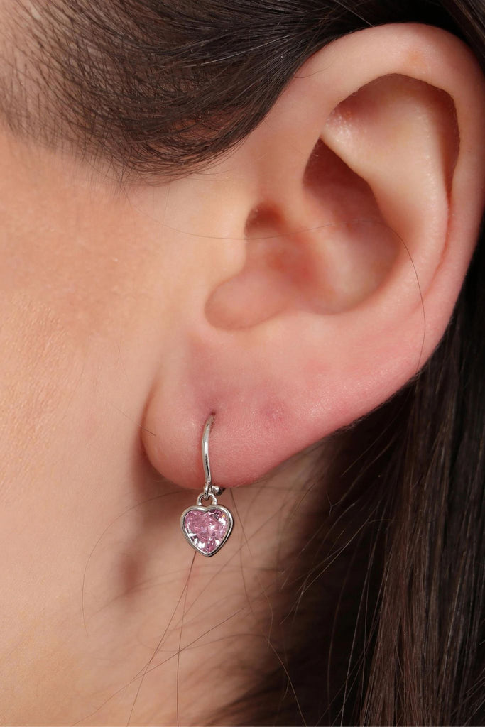 model wearing the silver and pink love heart dangle hoop earring