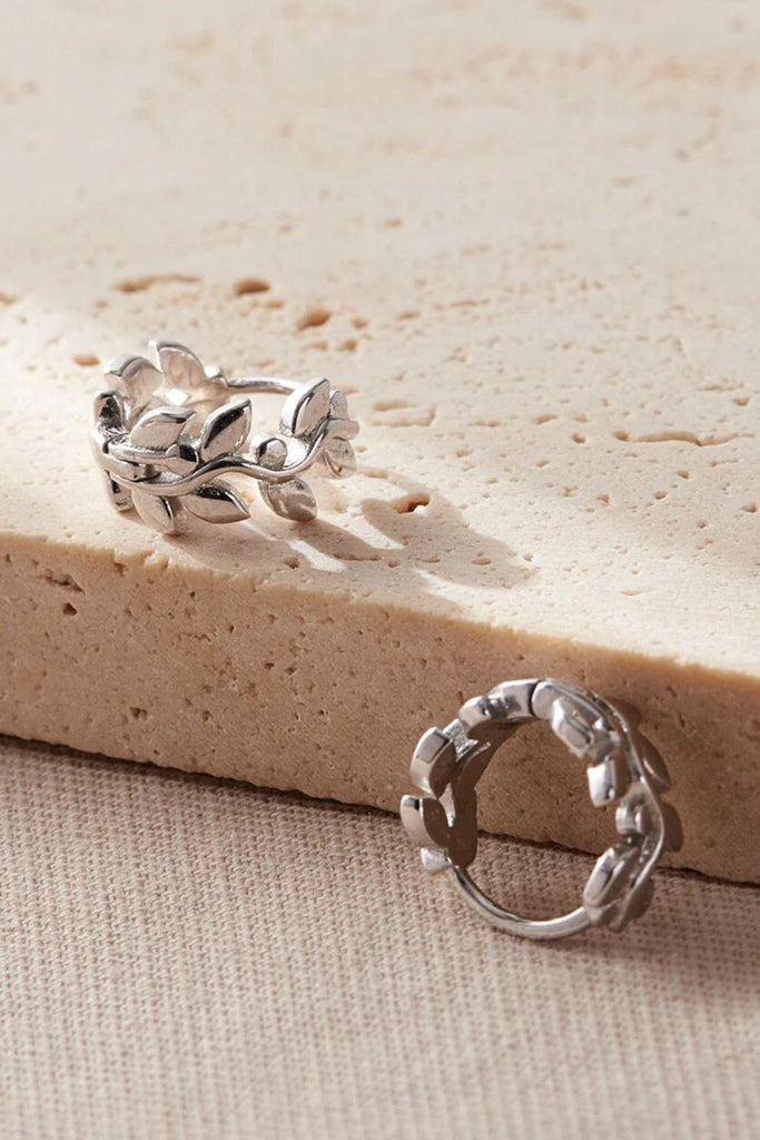 close up of the silver olive leaf huggie hoops