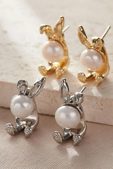 gold and silver coloured large rabbit shaped stud earrings, each earring has a pearl as the rabbits head