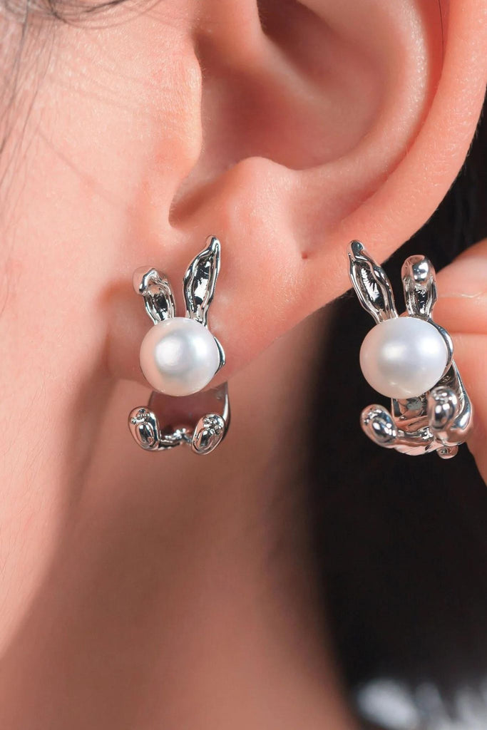 model wearing the silver rabbit stud earrings showing how they look when worn