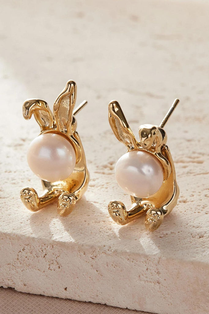 close up of the gold coloured pearl rabbit studs