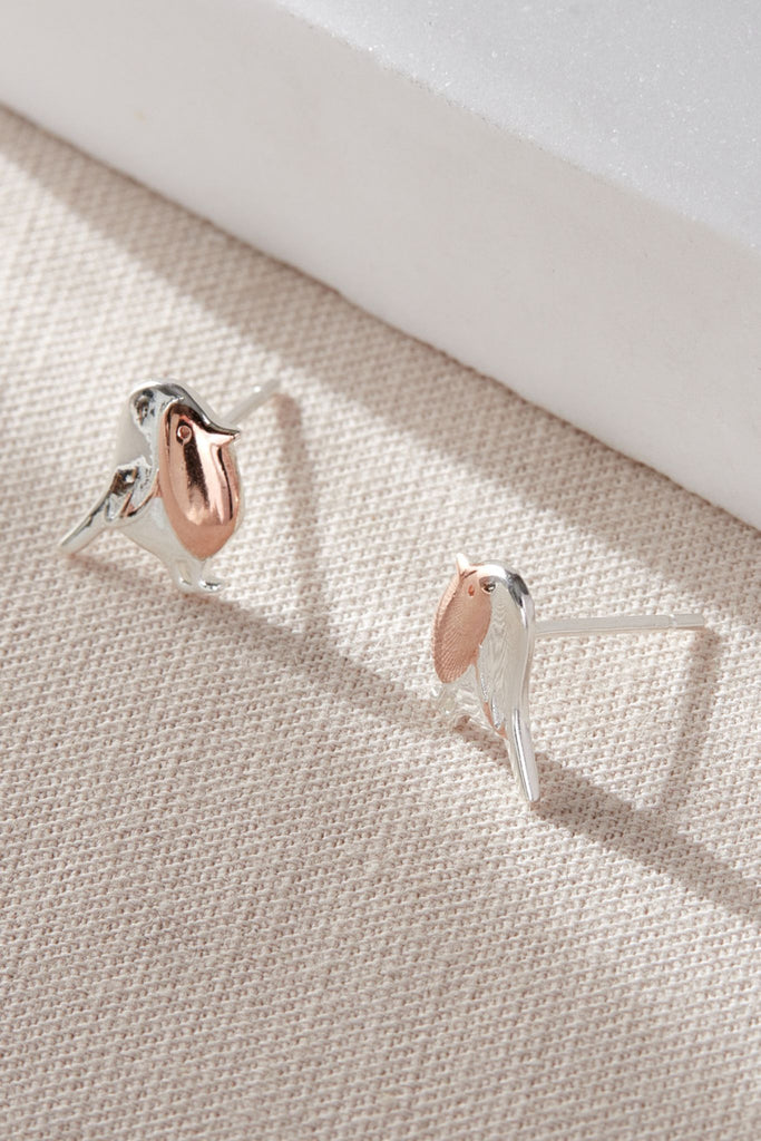 close up of the silver and rose gold stud earrings