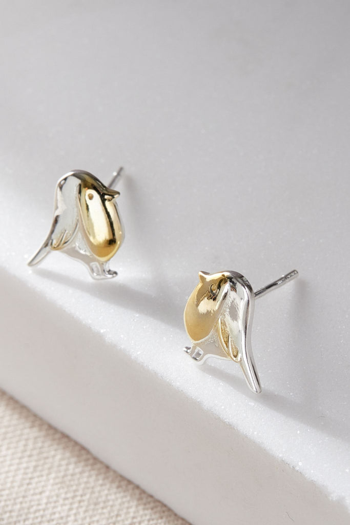 close up of the silver and  gold stud earrings