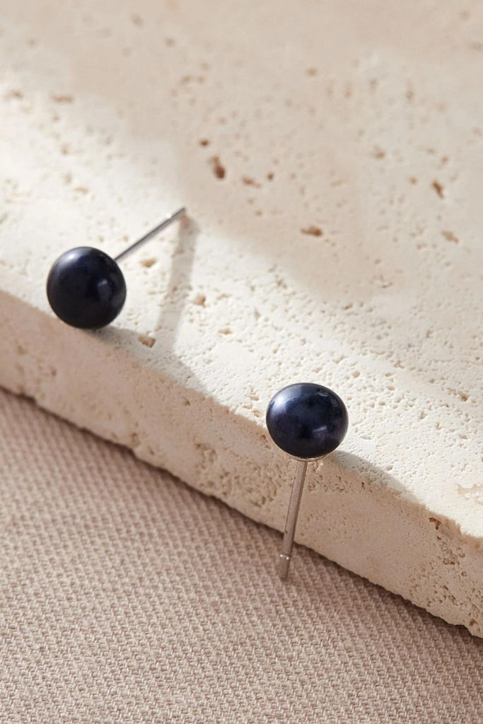 close up of the black pearl studs