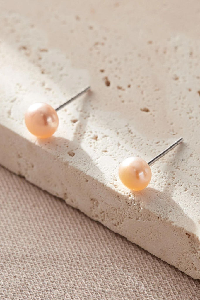close up of the coral pearl studs