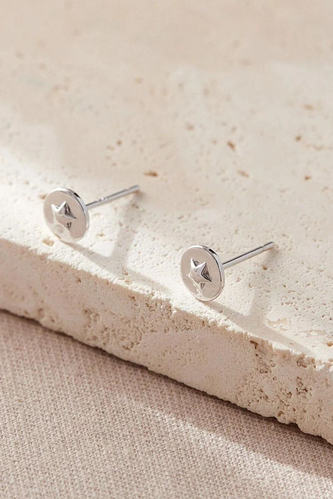 round stud earring in silver with raised stars in the middle