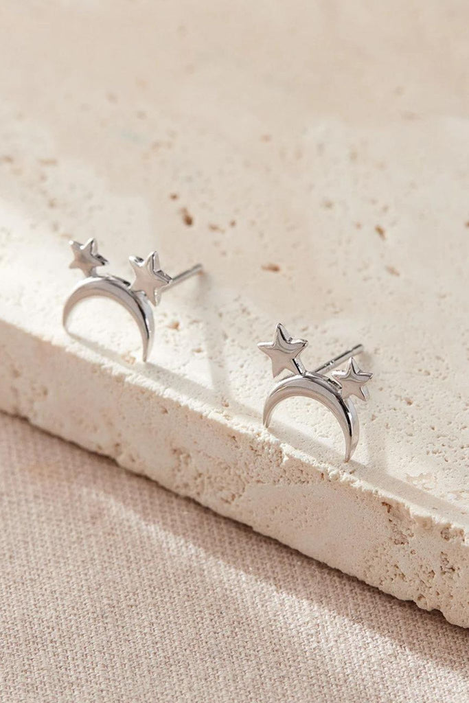close up of the silver moon and star stud earrings