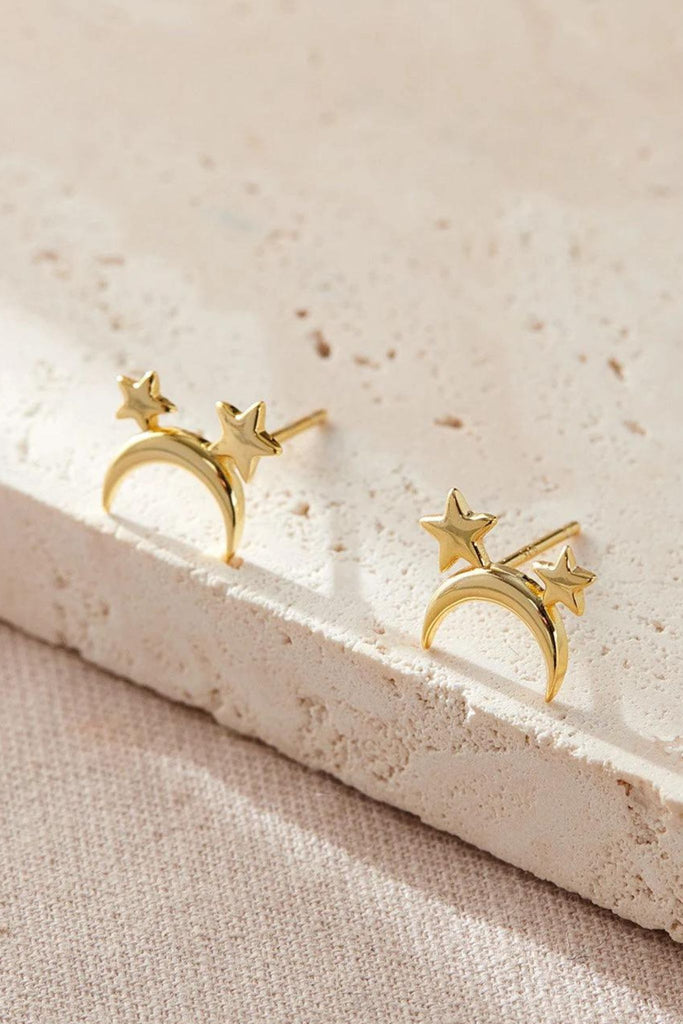 close up of the gold moon and star stud earrings