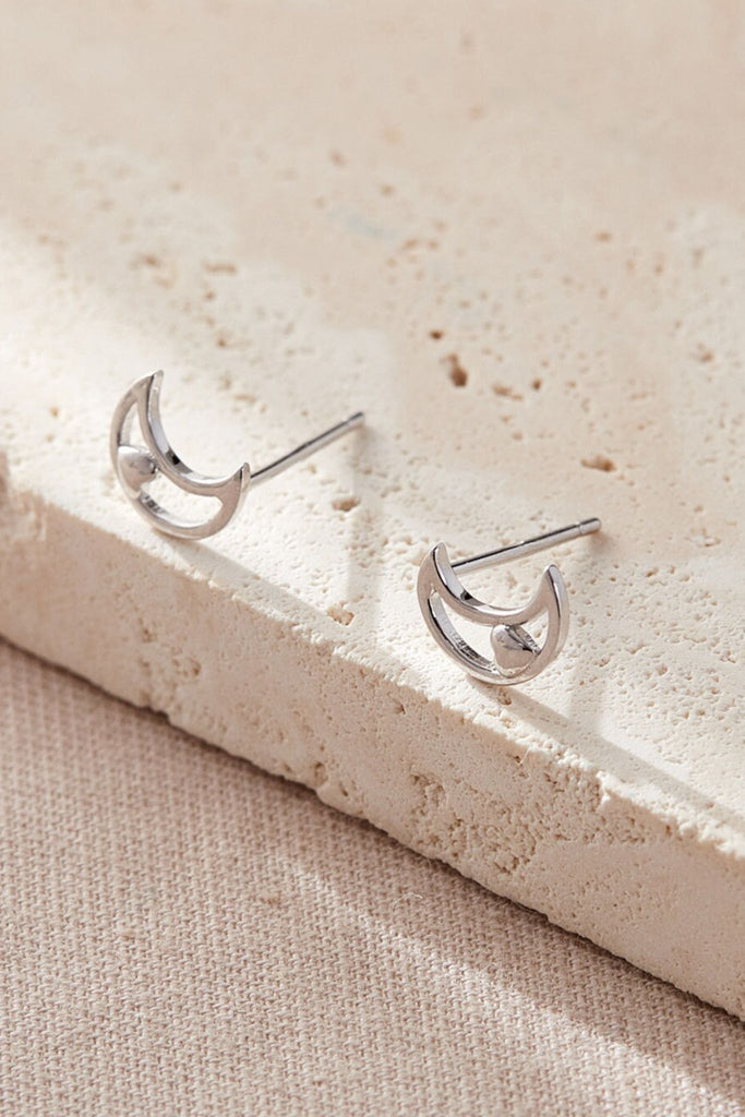 close up of the silver moon and heart stud earrings