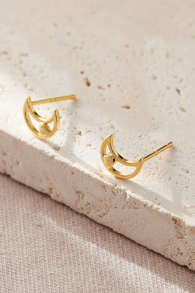 close up of the gold plated silver moon and heart stud earrings