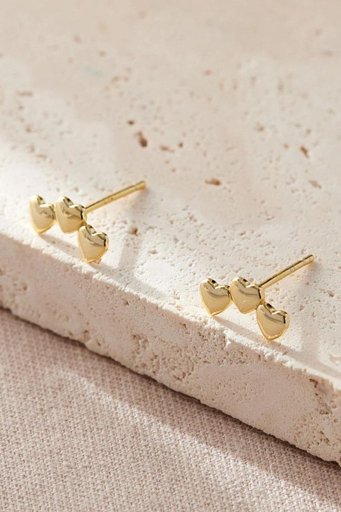 close up of the gold plated silver triple heart stud earrings