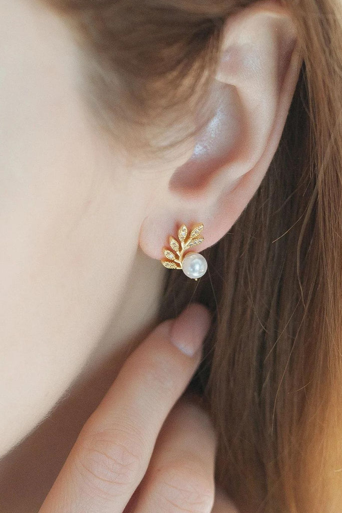 model wearing the sparkly pearl leaf earring on the earlobe showing how it looks when worn