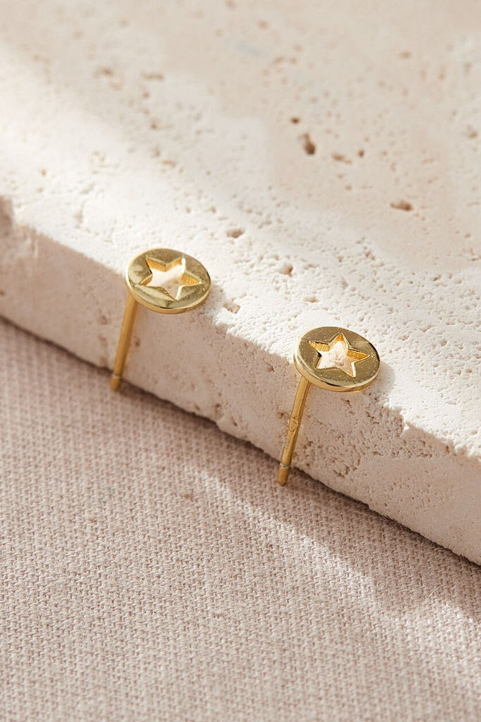 close up of the gold coloured hollow star stud earrings