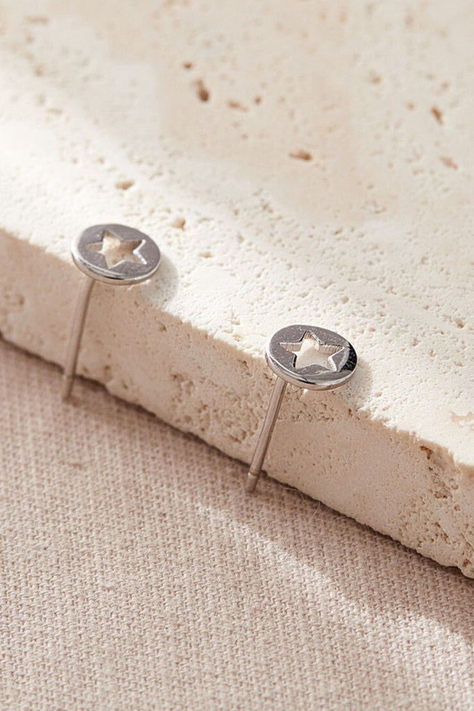 close up of the silver coloured hollow star stud earrings