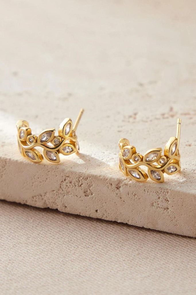 close up of the gold sparkly olive leaf earrings