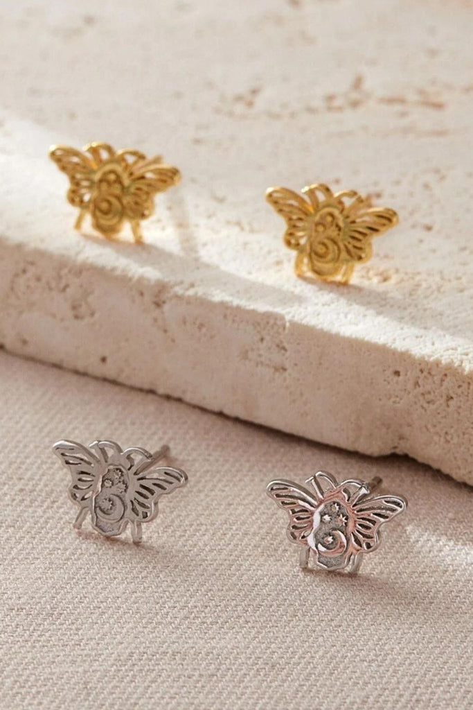 silver and gold bee stud earrings, the bees have a crescent moon and four dainty stars on them, giving them a celestial look