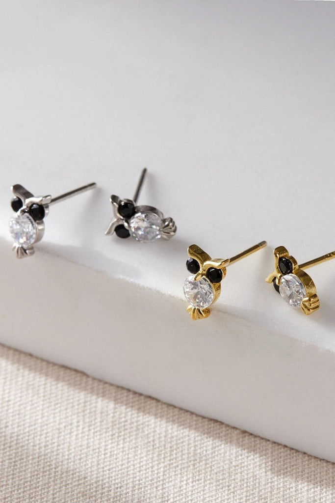 gold and silver stud earrings with cz accents, the earrings are designed to look like owls