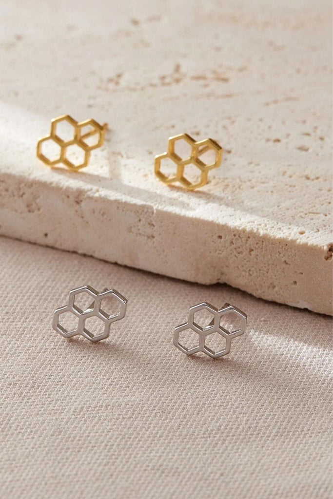 honeycomb stud earrings in silver and gold, each stud had four hexagonal honey comb shapes adjoined