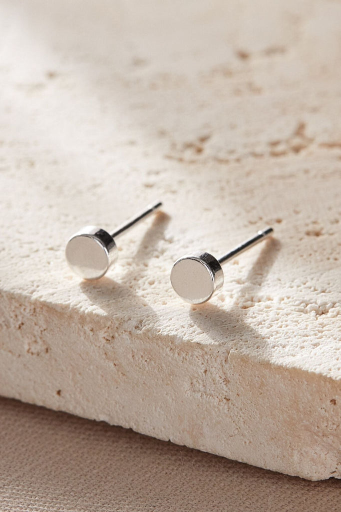 close up of the silver disc stud earrings