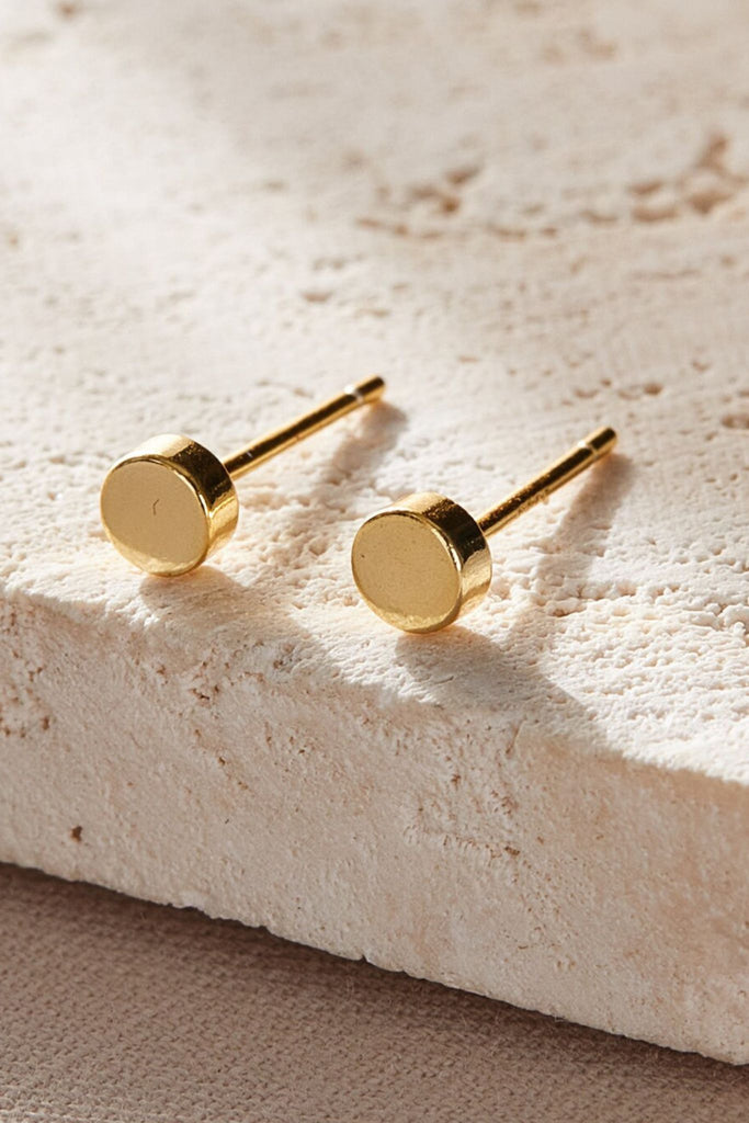 close up of the gold plated silver disc stud earrings