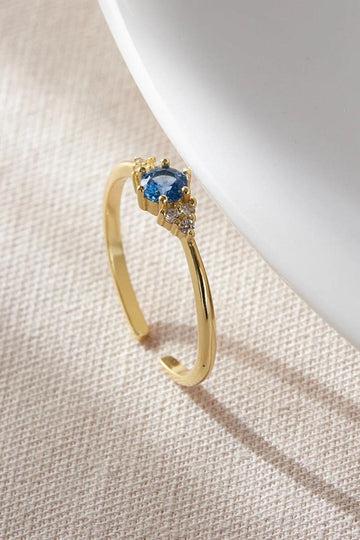 close up of the blue sparkly gold ring, showing the open adjustable band