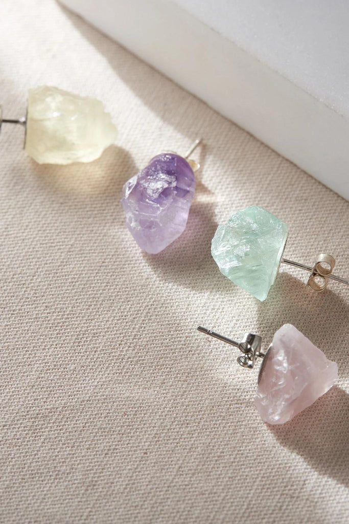 large rough cut crystals mounted on stainless steel earring backs, the crystals come in pink, green, purple and yellow colours