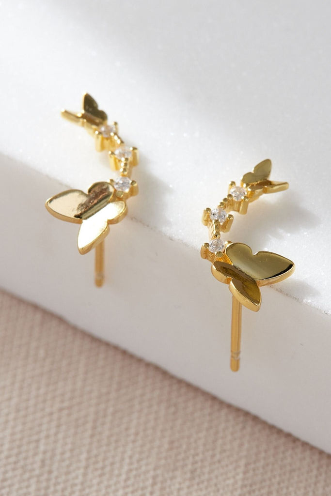 close up of the gold buttefly stud earrings