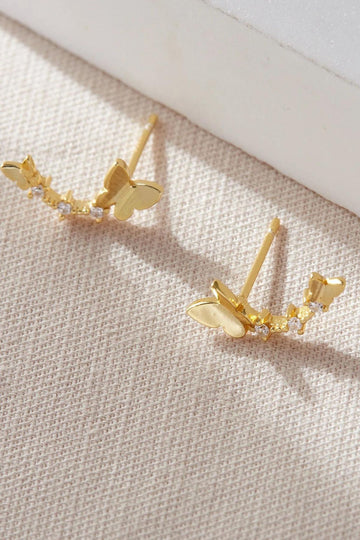 gold coloured sterling silver earrings featuring two gold butteflies with three tiny cz flowers between them